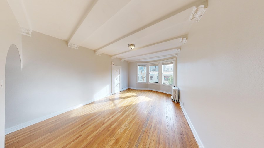 A room with wooden floors and white walls.